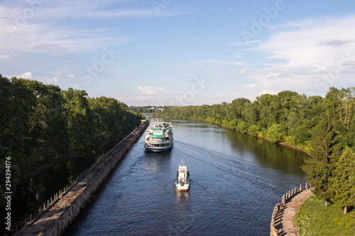 Uglich. cruise ship passes through the gateway of the Uglich hydroelectric power station