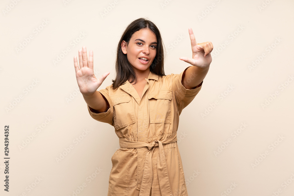 Young girl over isolated background counting seven with fingers Young girl over isolated background counting seven with fingers