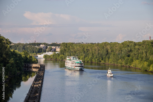 Uglich. cruise ship passes through the gateway of the Uglich hydroelectric power station