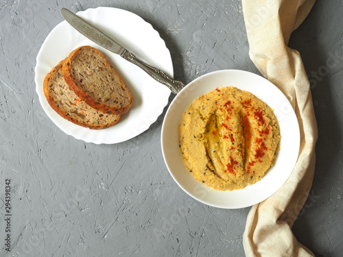 Classic hummus with hot pepper on a white plate. National, vegetarian dish.