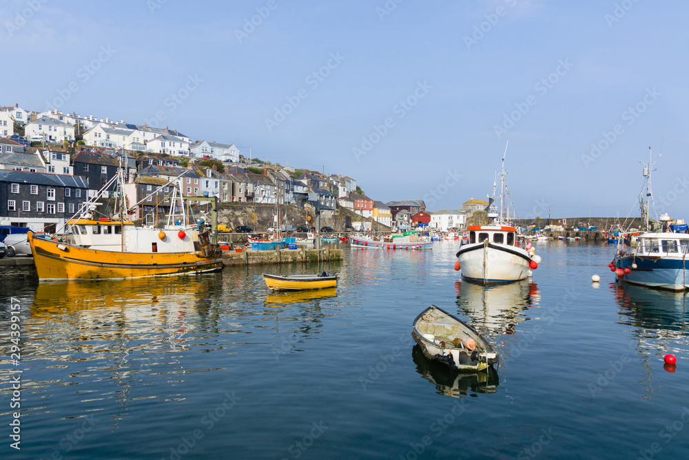 Obraz premium Mevagissey harbour in Cornwall with fishing boats at anchor the village is a popular tourist destination