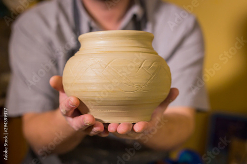 Potter showing earthenware pot