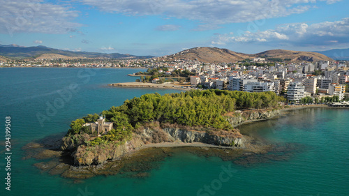 Fototapeta Naklejka Na Ścianę i Meble -  Aerial drone photo of iconic lighthouse built in small islet in famous city of Halkida or Chalkida with clear water seascape and beautiful sky - clouds, Evia island, Greece