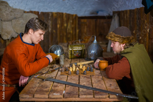 Two men playing popular strategy board game - tafl photo