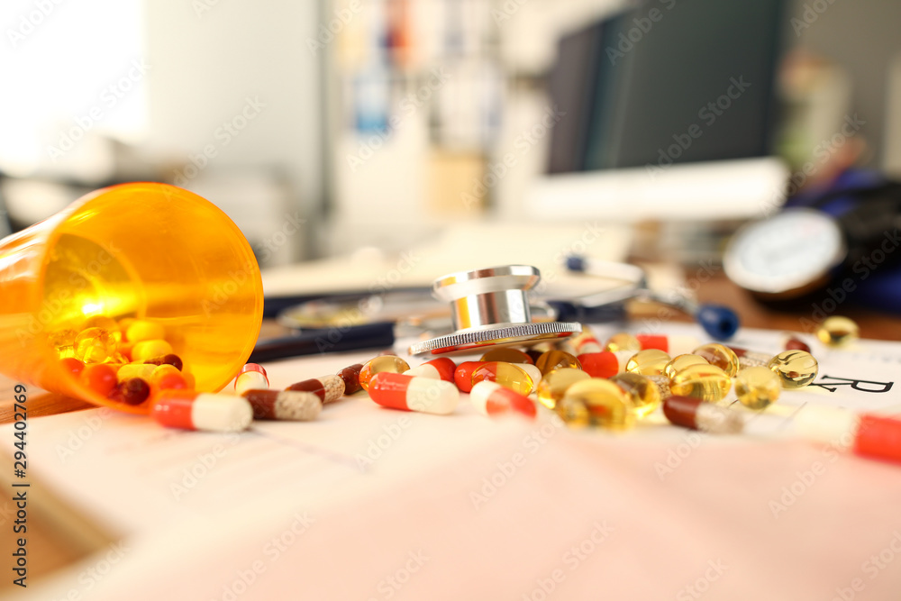 Pile of tablets lying over prescription application form Pile of tablets lying over prescription application form
