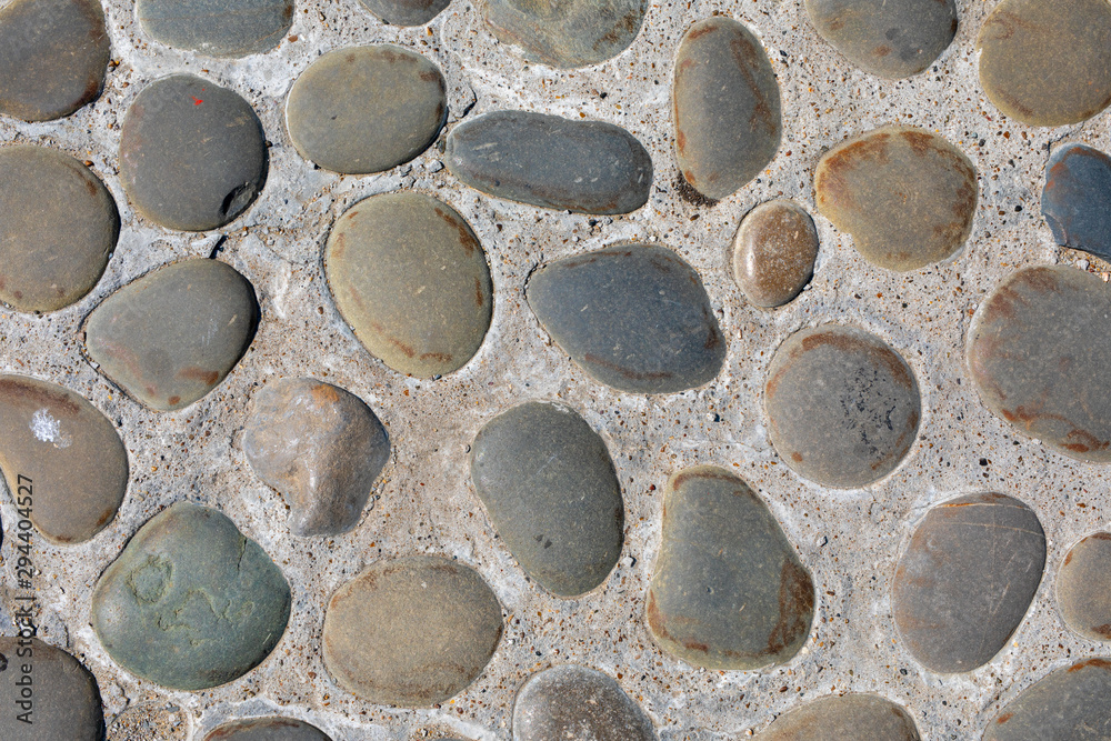 Abstract background of cobblestone pavement close-up. Top view on stone road close up. High resolution photo. Mock up. Abstract background of cobblestone pavement close-up. Top view on stone road close up. High resolution photo. Mock up.