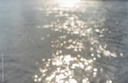 Water surface with ripples and sunlight reflections