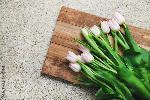 Pink tulip flowers on the wooden board