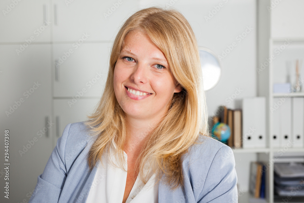 Smiling blond woman in business suit