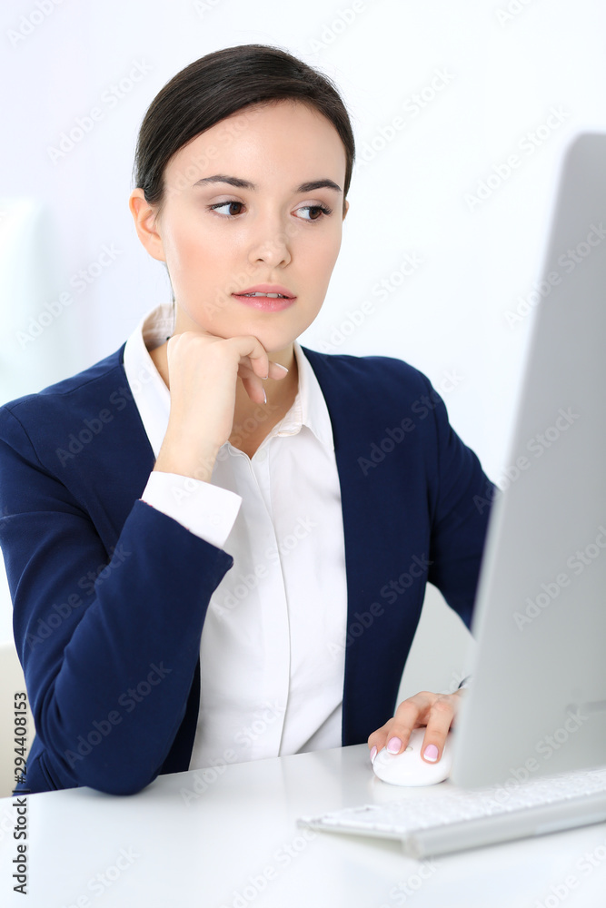 Business woman working with computer in office. Headshot of Lawyer or accountant at work while sitting at the desk Business woman working with computer in office. Headshot of Lawyer or accountant at work while sitting at the desk