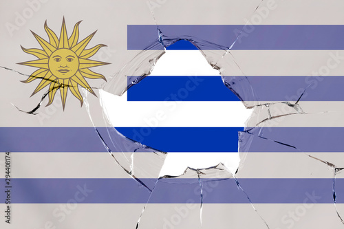 Flag of Uruguay on a on glass breakage. photo