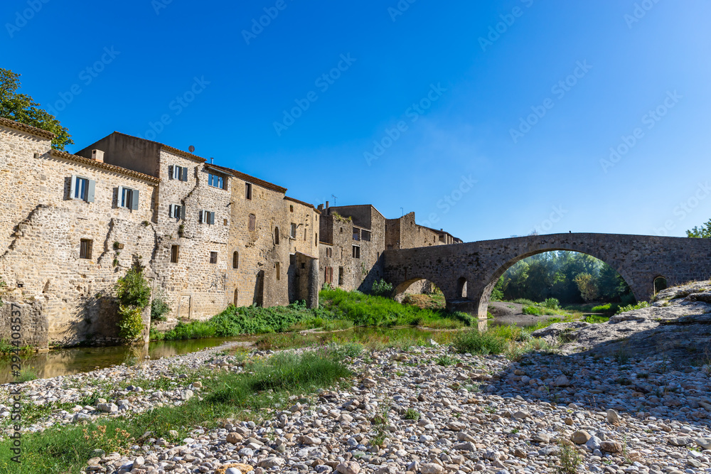 Perspective of the Romanesque bridge, was built in the 12th century. Lagrasse, Occitanie, France.