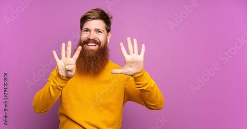 Redhead man with long beard over isolated purple background counting nine with fingers © luismolinero