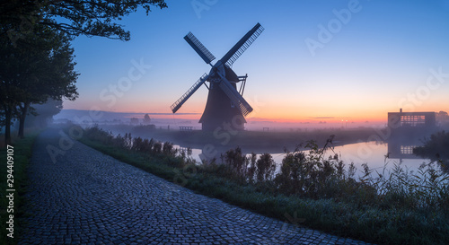 Windmill during a foggy dawn in the Dutch countryside. Krimstermolen, Zuidwolde. photo