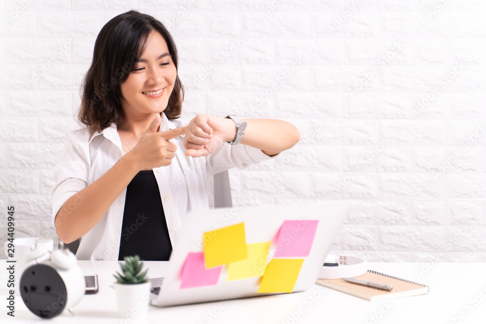 Happy woman holding hand with wrist watch