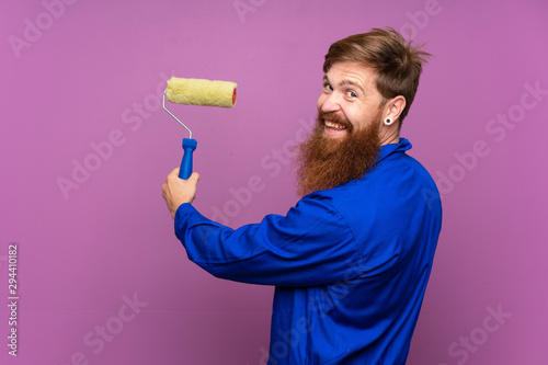 Painter man with long beard over isolated purple background