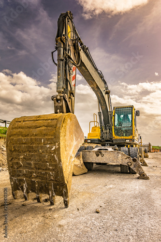 Excavator to level and smooth the land in the construction of a road