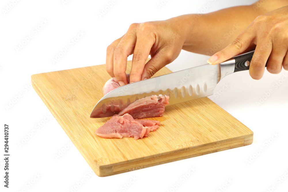 A female chef chopping raw meat