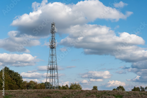 Telecommunication Tower Against Cloudy Blue Sky