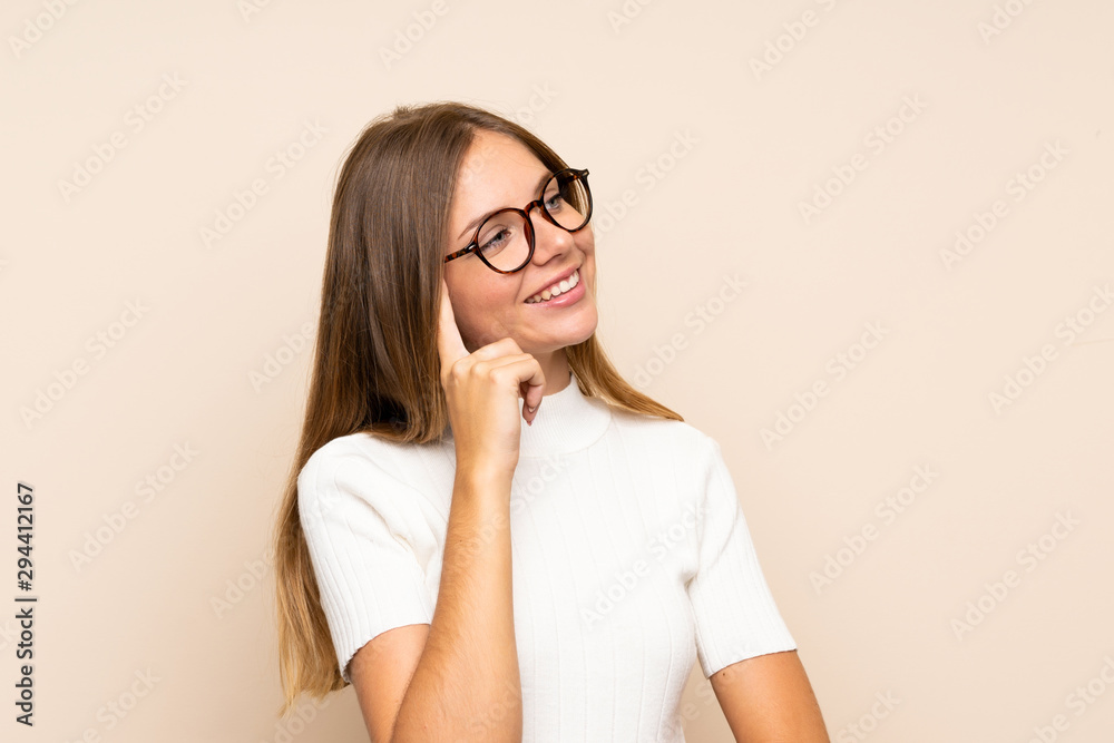 Young blonde woman over isolated background with glasses