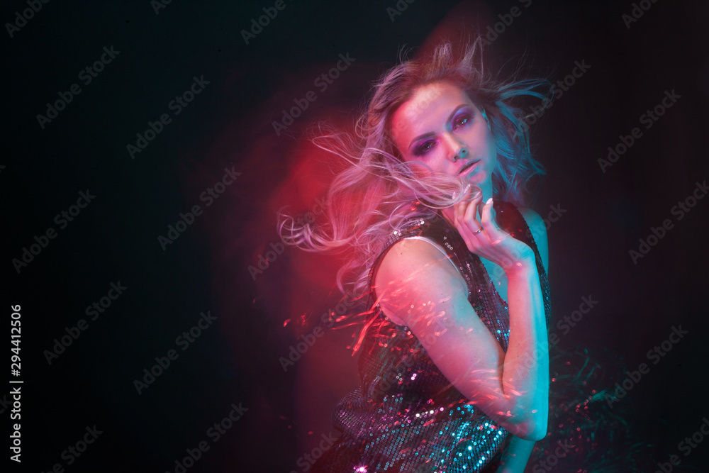 Attractive dancing blonde in the club, neon light, motion effects Attractive dancing blonde in the club, neon light, motion effects