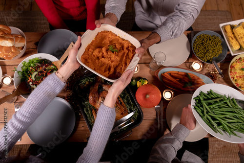Millennial adult friends celebrating Thanksgiving together at home 