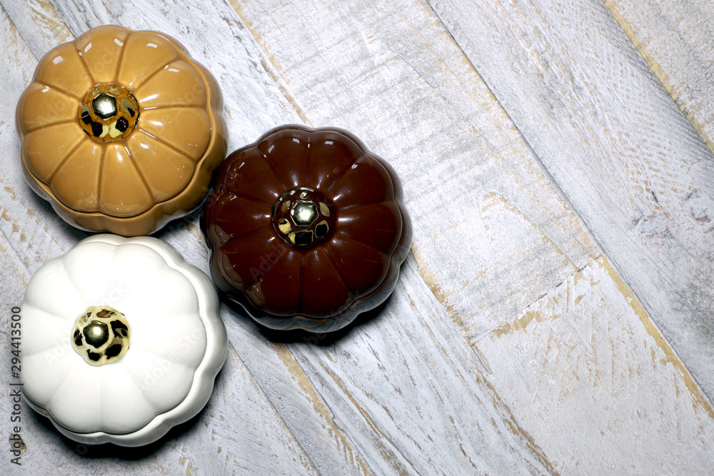 Glass Pumpkins against distressed wooden surface backbround Glass Pumpkins against distressed wooden surface backbround