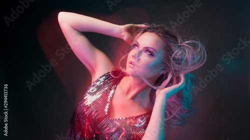 Attractive dancing blonde in the club, neon light, motion effects © Ulia Koltyrina