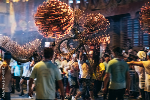 Tai Hang Fire Dragon Dance - People performing the dance by holding the body of the dragon, dragon ball and dance through the street