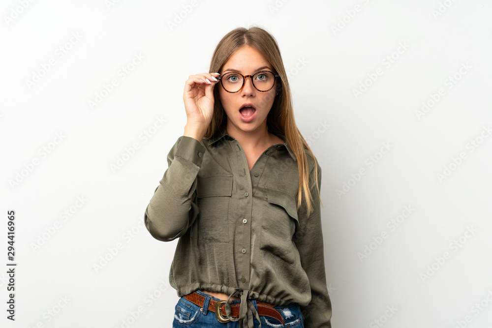 Lithuanian blonde girl over isolated white background with glasses and surprised Lithuanian blonde girl over isolated white background with glasses and surprised