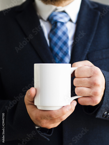 Close-up elegant man holding up mug