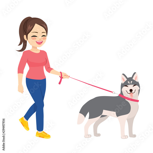 Happy young woman walking with husky dog pet
