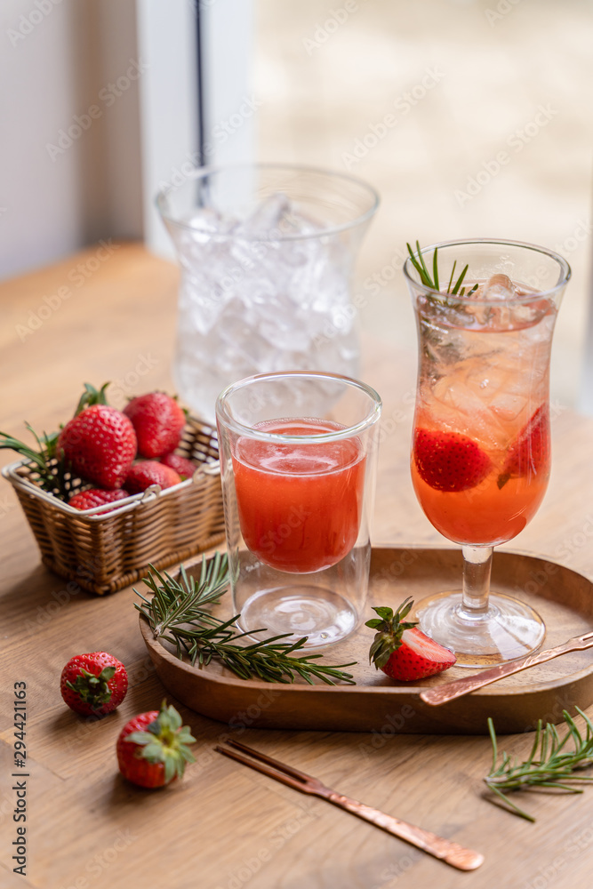 Refreshing summer drink cocktail with Strawberry and ice cubes in jug and glasses infused water on the wooden table. Refreshing summer drink cocktail with Strawberry and ice cubes in jug and glasses infused water on the wooden table.