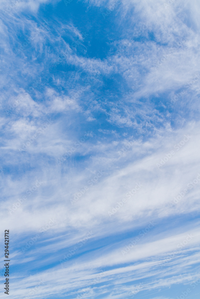 White fluffy clouds in the blue sky in summer White fluffy clouds in the blue sky in summer