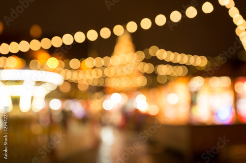 winter holidays and celebration concept - blurred christmas market in winter evening at town hall square in tallinn, estonia © Syda Productions