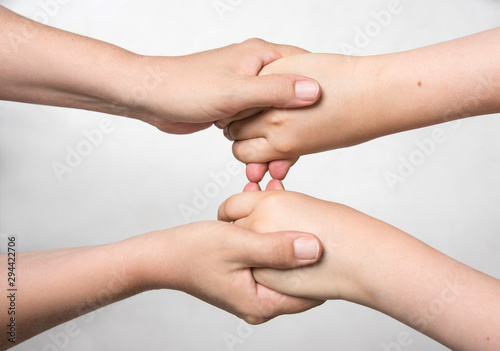 Hands holding eachother with care. Family connection. Social concept.