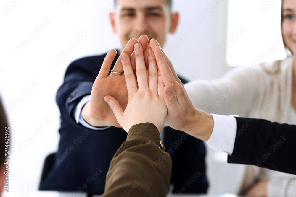Business people group showing teamwork and joining hands or giving five after signing contract in modern office. Unknown businessman and woman with colleagues or lawyers making circle with their hands Business people group showing teamwork and joining hands or giving five after signing contract in modern office. Unknown businessman and woman with colleagues or lawyers making circle with their hands