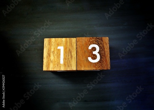 13 on wooden calendar. bad luck, Misfortune Day, Halloween Concept. © BooDogz