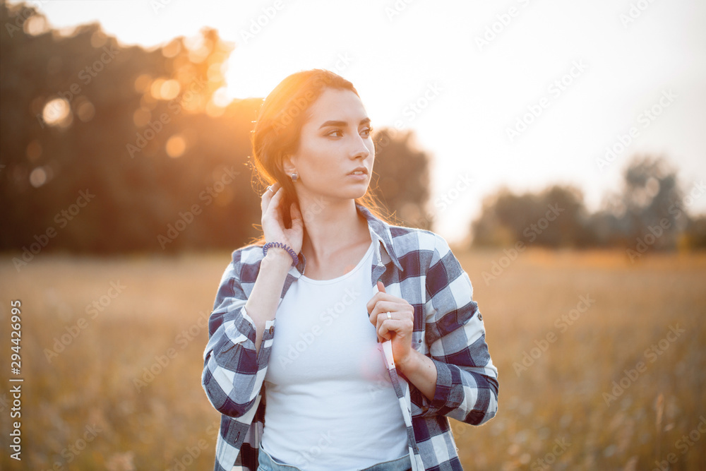Portrait of beautiful young woman outdoors at sunset