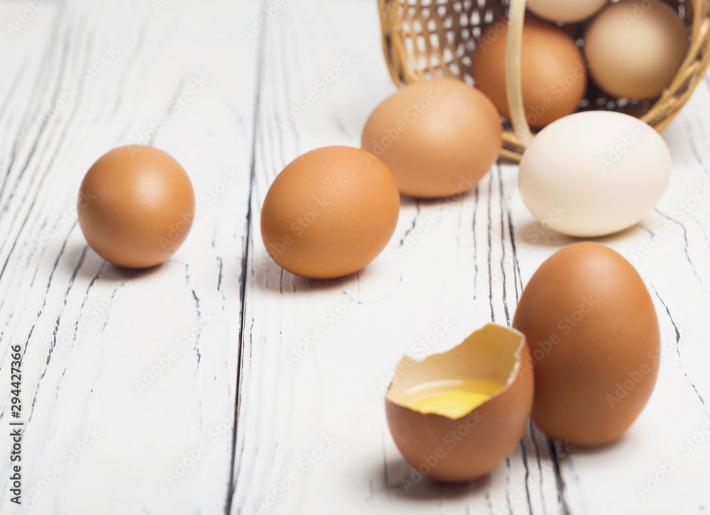 Chicken eggs. A useful product is a lot of calcium and protein. Ecological eggs on a white wooden table. Chicken eggs. A useful product is a lot of calcium and protein. Ecological eggs on a white wooden table.