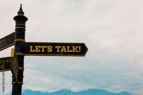 Conceptual hand writing showing Let S Talk. Concept meaning they are suggesting beginning conversation on specific topic Road sign on the crossroads with blue cloudy sky in the background photo