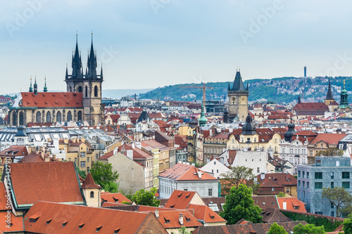 Aerial view of citycape of old town of Prague, with a lot of red rooftops and The Church of Mother of God before Týn, and the power tower.