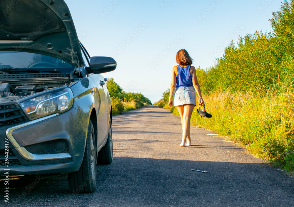 Beautiful young girl, in despair, she can not continue her journey because of the fact that her car broke down. Beautiful young girl, in despair, she can not continue her journey because of the fact that her car broke down.