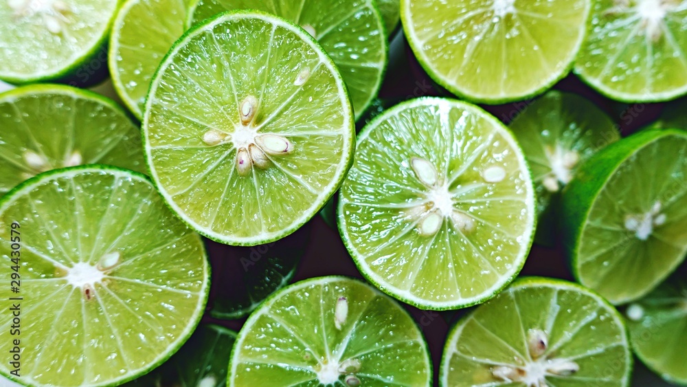 Lime Background. Close up shot of limes. Selective Focus of sliced lime.