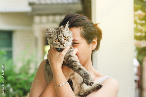 Woman playing with her persian cat.