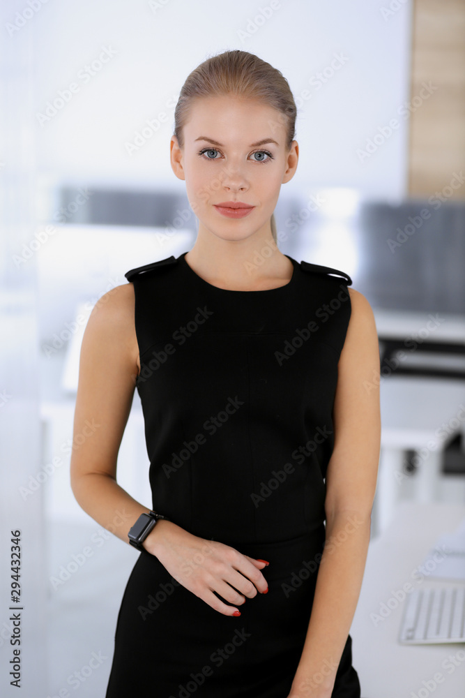 Business woman headshot in modern office. Secretary or female lawyer looks beautiful in black dress. Business people concept Business woman headshot in modern office. Secretary or female lawyer looks beautiful in black dress. Business people concept