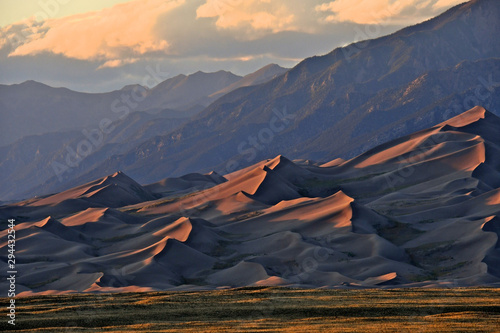 Low angle late afternoon light illuminates dunes and casts shadows, Great Sand Dunes National Park and Preserve, Colorado photo