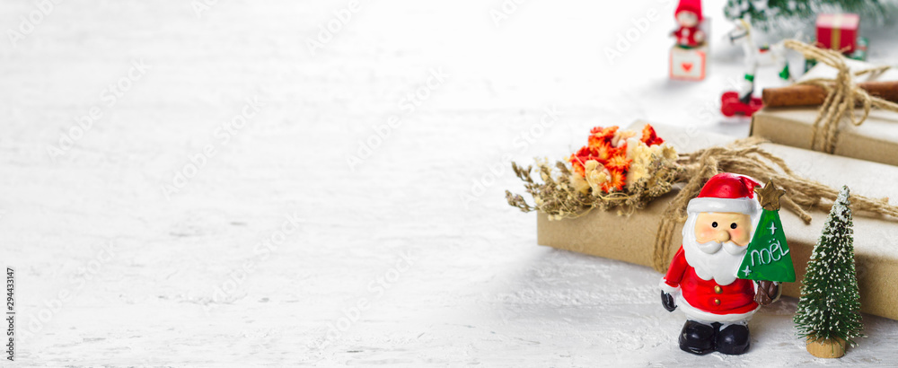 Merry Christmas and Happy new year web banner. Santa Clause toys with  Natural Christmas gift box with pine tree and Christmas toys decoration on  white snow wood background Stock Photo | Adobe