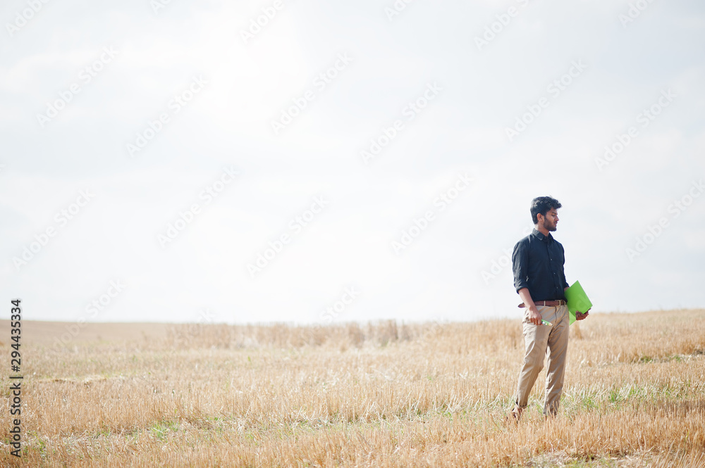 South asian agronomist farmer inspecting wheat field farm. Agriculture production concept. South asian agronomist farmer inspecting wheat field farm. Agriculture production concept.