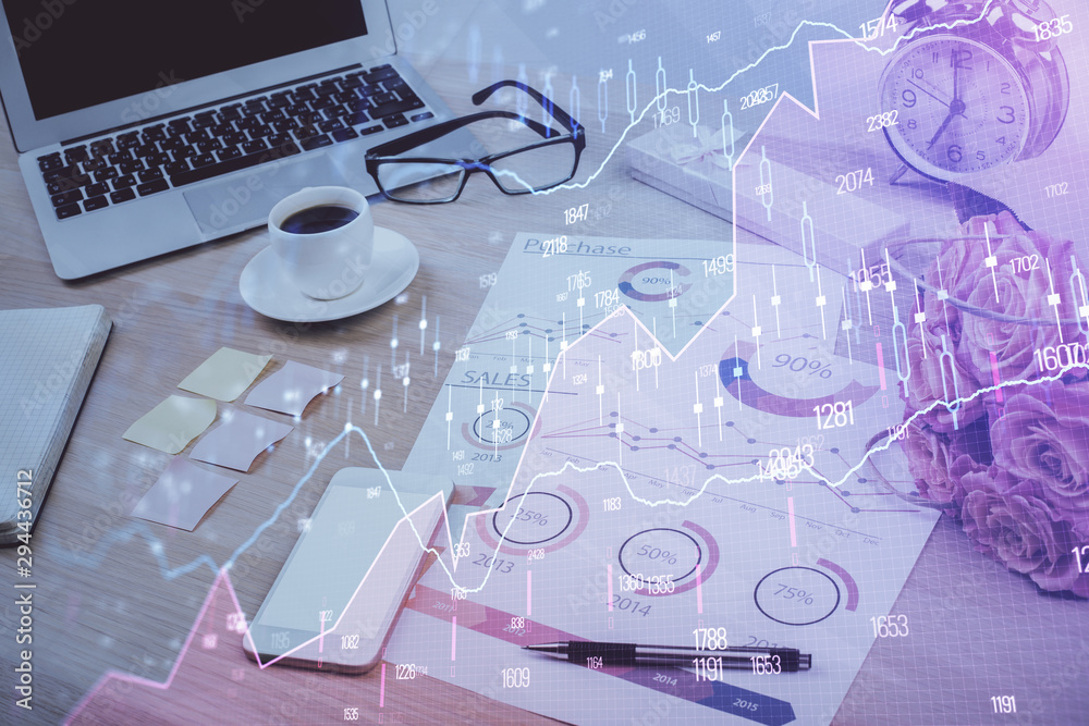 Financial chart drawing and table with computer on background. Multi exposure. Concept of international markets. Financial chart drawing and table with computer on background. Multi exposure. Concept of international markets.